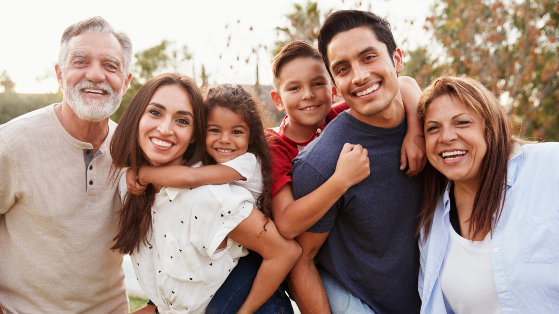 A happy multigenerational family smiling together, symbolizing love, support, and bonding.