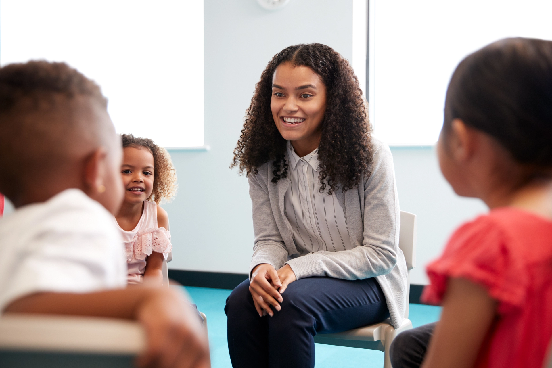Children sitting listening to teacher