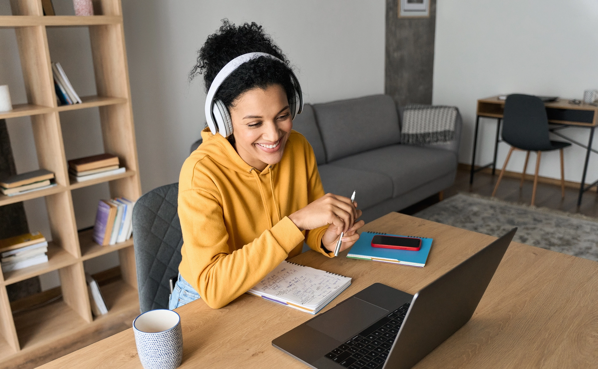 Student wearing headphones having a virtual class