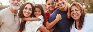 A happy multigenerational family smiling together, symbolizing love, support, and bonding.